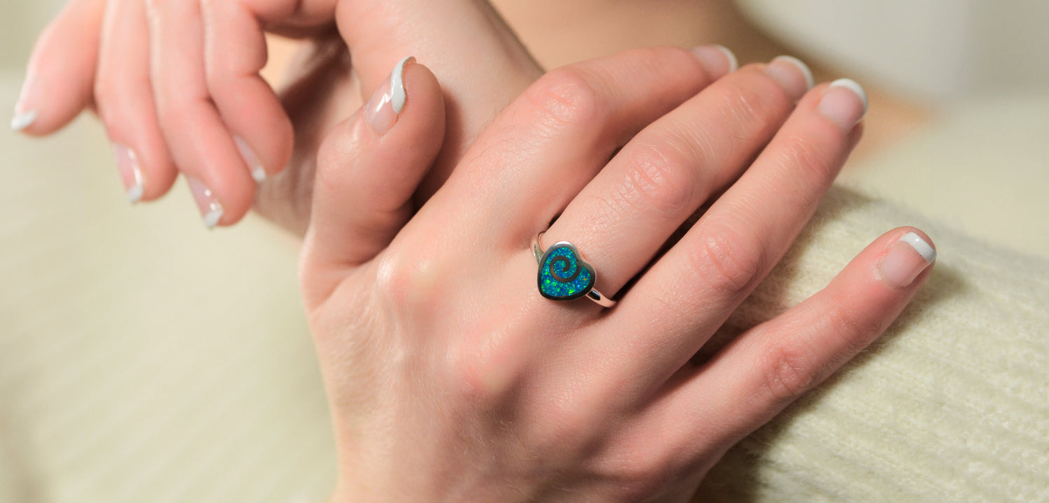 Opals & Ashes Angel Feather Memorial Ring Silver. Modelled on female hand. Ashes blended with Royal Blue Opals.