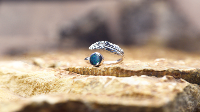 Angel Feather Ladies Ashes Ring Cast in sterling silver filled with emerald green opals blended with customers loved one’s ashes.