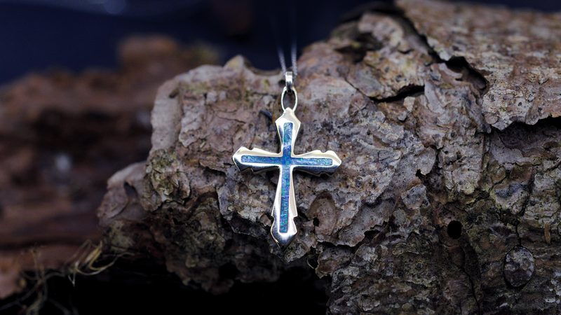 Decorative Cross Ashes Pendant. Cast in 9ct Yellow Gold, filled with Pacific Blue opals blended with customers loved one’s ashes.