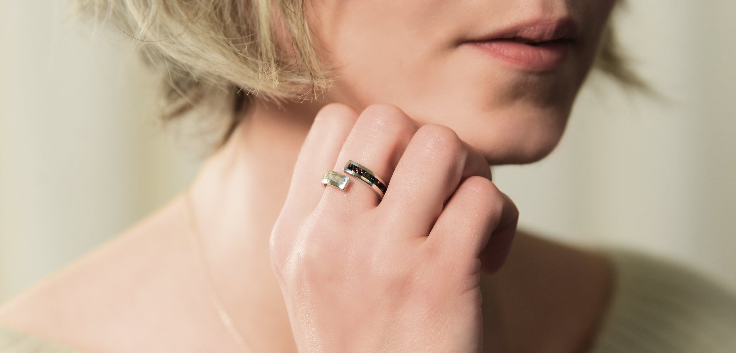 Opals & Ashes Dual Spiral Memorial Ring Silver. Modelled on female hand. Ashes blended with Black Fire and Pearl White Opals.