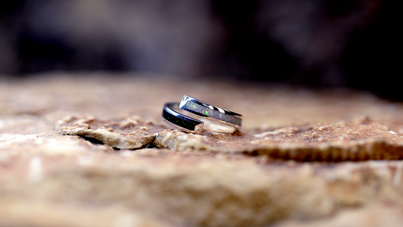 Dual Spiral Ashes Ring Cast in sterling silver filled with black fire and pearl white opals blended with customers loved one’s ashes.