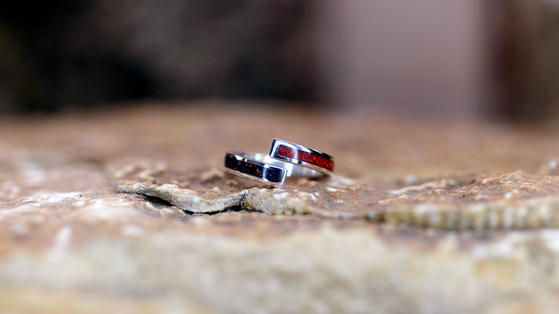 Dual Spiral Ashes Ring Cast in sterling silver filled with black fire and ruby red opals blended with customers loved one’s ashes.