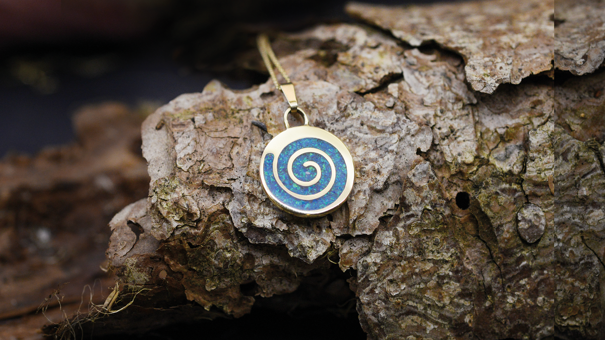Spiral Ashes Pendant. Cast in 9ct Yellow Gold, Filled with pacific Blue opals blended with customers loved one’s ashes.