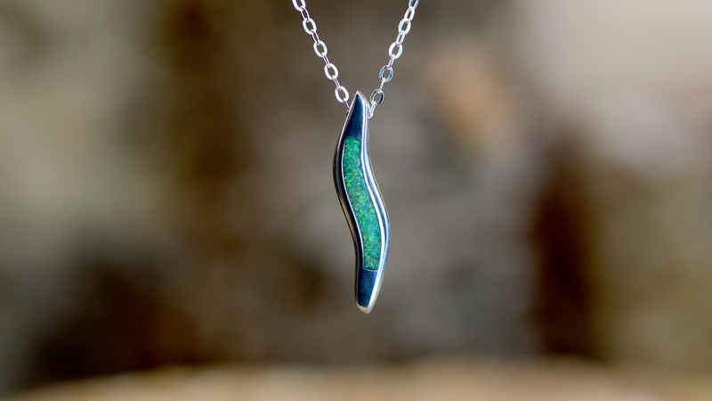 Wave Ashes Pendant. Cast in sterling silver, filled with spring green opals blended with customers loved one’s ashes.